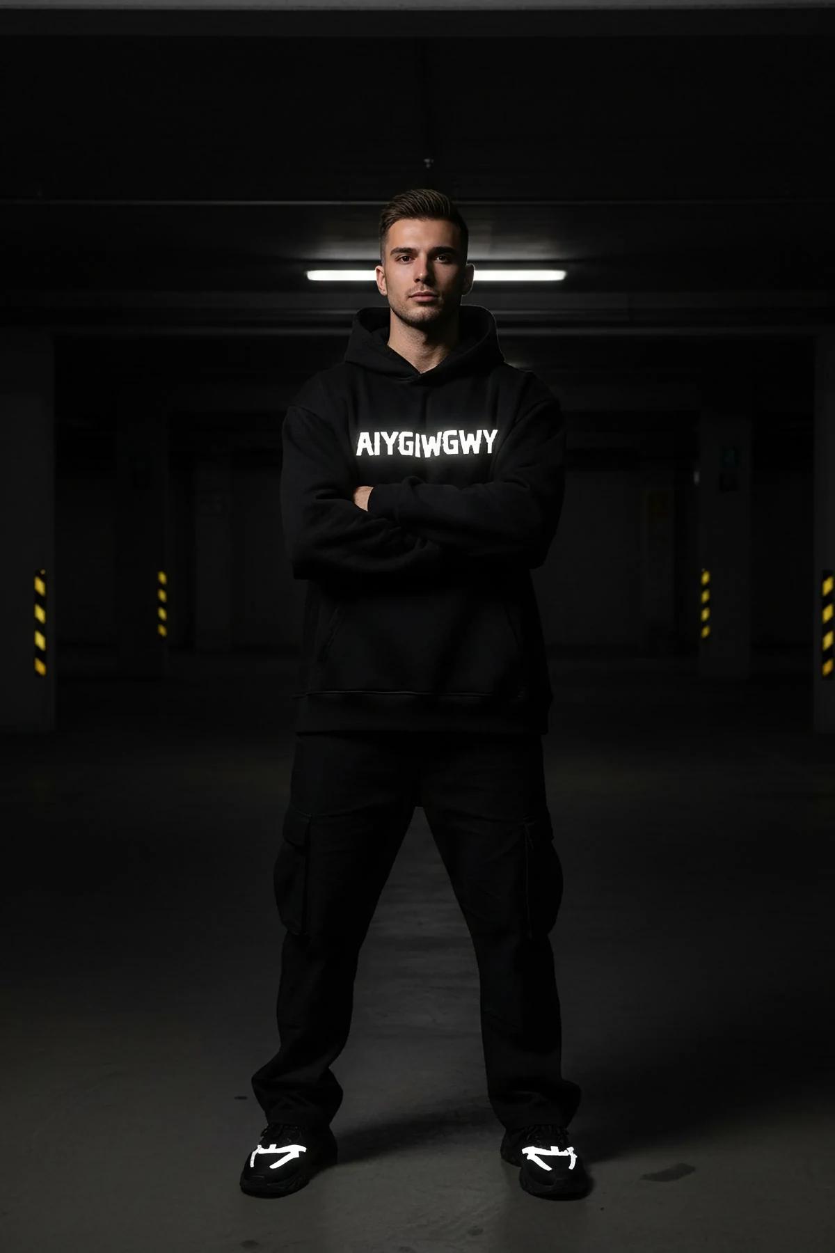Reflective glow-in-the-dark hoodie black full outfit with custom text and matching shoes in dark setting