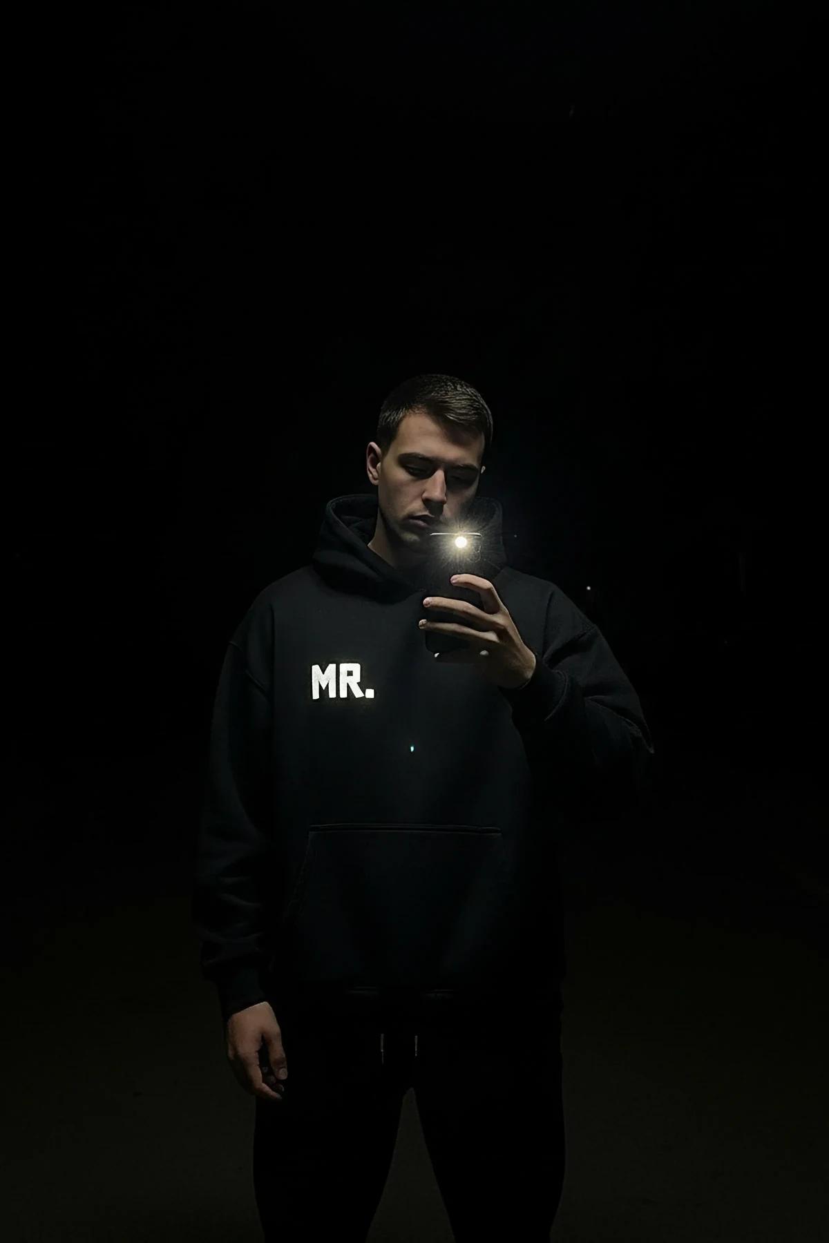 Reflective black hoodie with glow-in-the-dark MR. print for festival outfit
