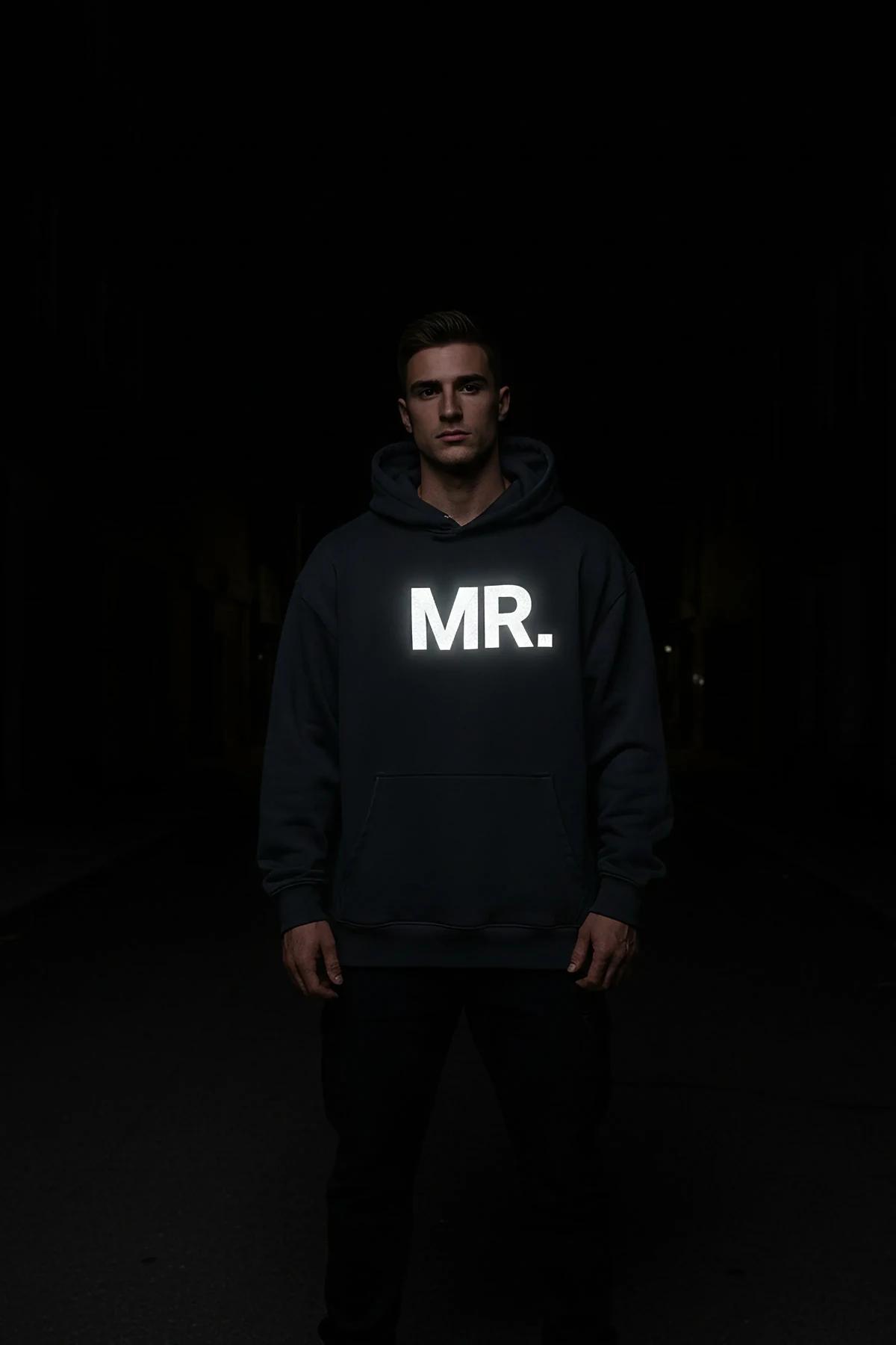 Reflective MR. Hoodie in navy blue with glow-in-the-dark front print visible in low light setting