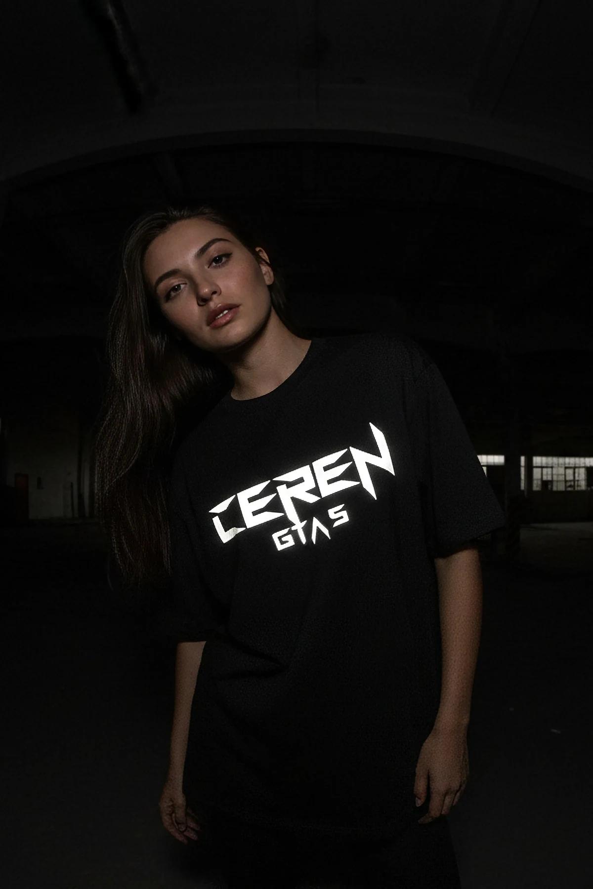 Glow-in-the-dark black oversized t-shirt with Ceren GTA 5 logo glowing in low light festival style