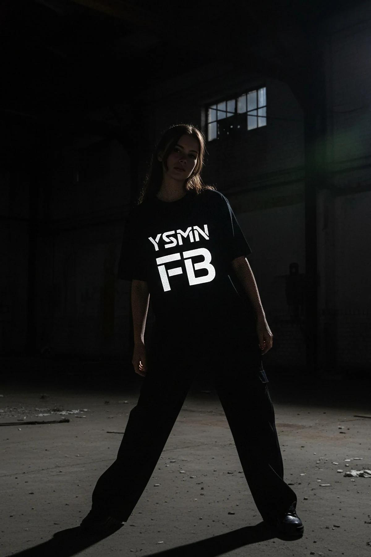 Black t-shirt with reflective YSMN FB logo graphic on front