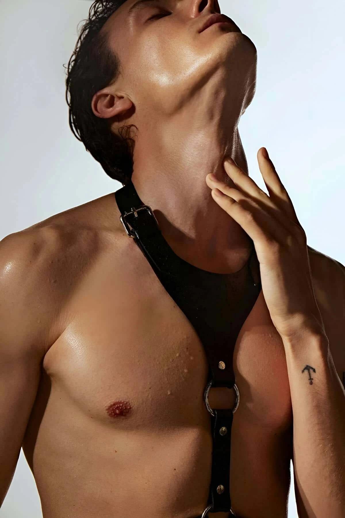 Black faux leather adjustable O-ring chest harness worn by a person.