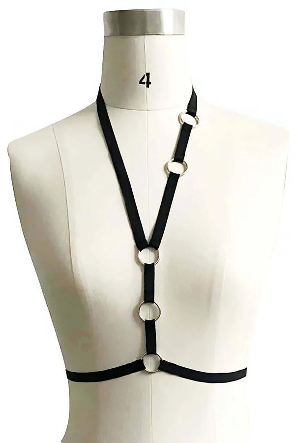 Black elastic chest harness with four silver O-rings on a dress form, flat straps from collar to underbust band