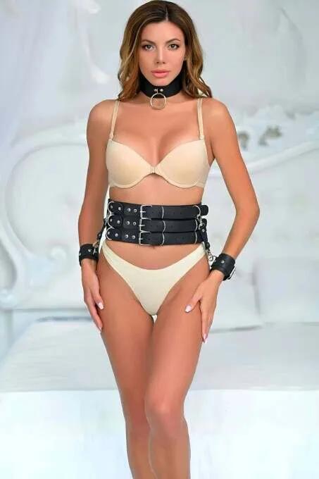 Black faux leather triple strap waist harness belt set with wrist cuffs and O-ring choker, worn together