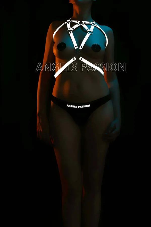 White reflective body harness with silver O-rings geometric cage strap design on dark background