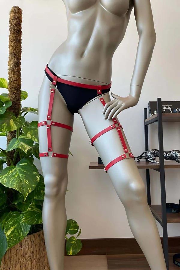 Red faux leather adjustable thigh harness with silver O-rings and stacked straps on mannequin