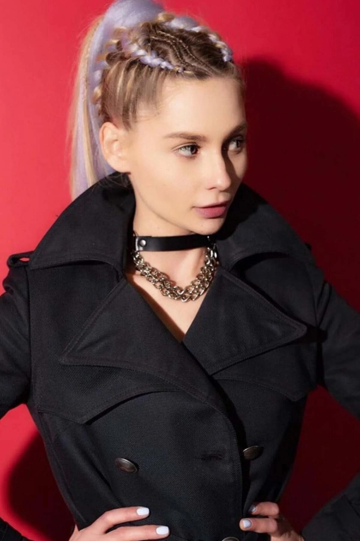 Black faux leather choker necklace with gold-tone chunky chain drop worn close to throat
