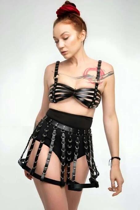 black faux leather chest harness and cage skirt set with silver O-rings multi-strap structured two-piece
