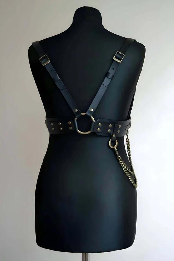 Black faux leather body harness back view with antique bronze O-ring rivet studs and chain drop on mannequin