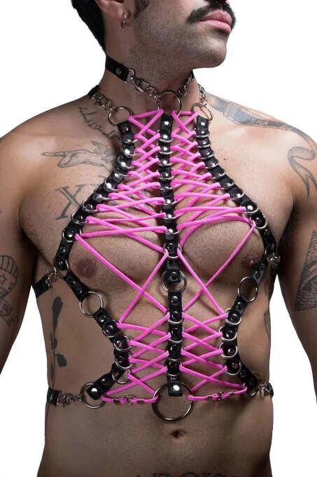 Black faux leather chest harness with neon pink criss-cross lacing and silver O-rings worn by man