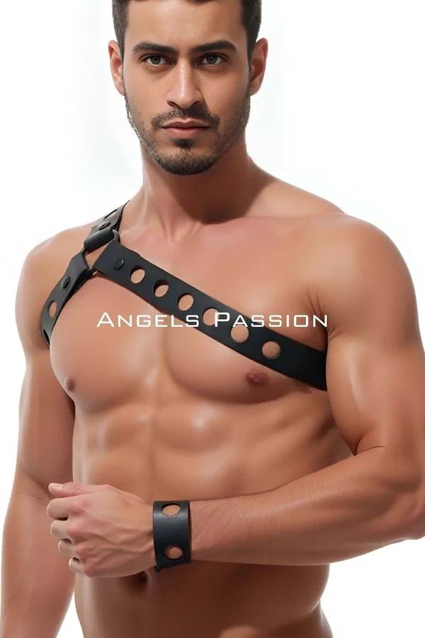 black faux leather asymmetrical chest harness with punched grommet holes diagonal single strap worn by male model