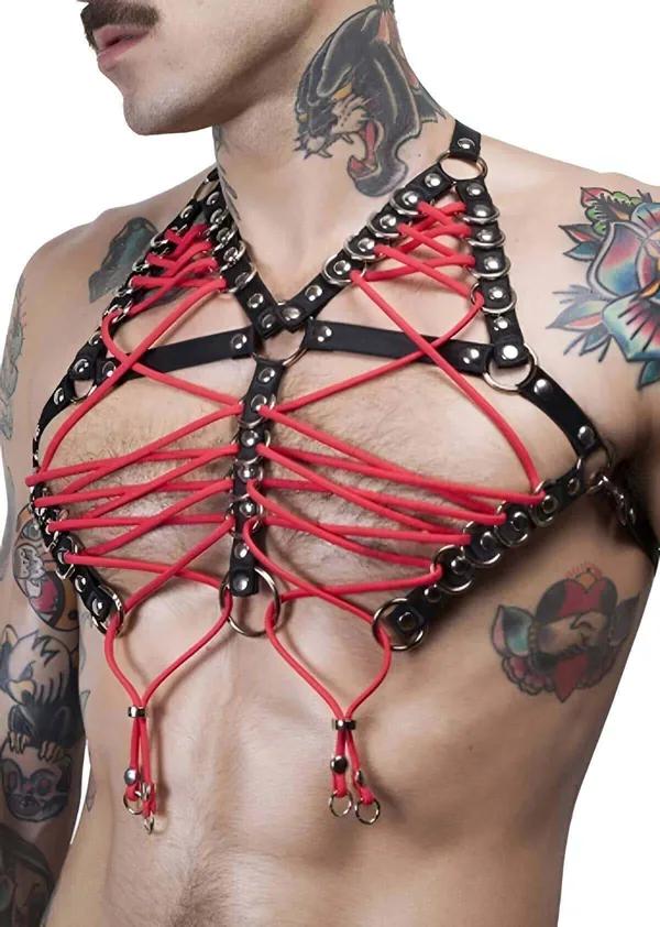 Red lacing black faux leather chest harness with silver O-rings on tattooed male torso, criss-cross elastic cord web design